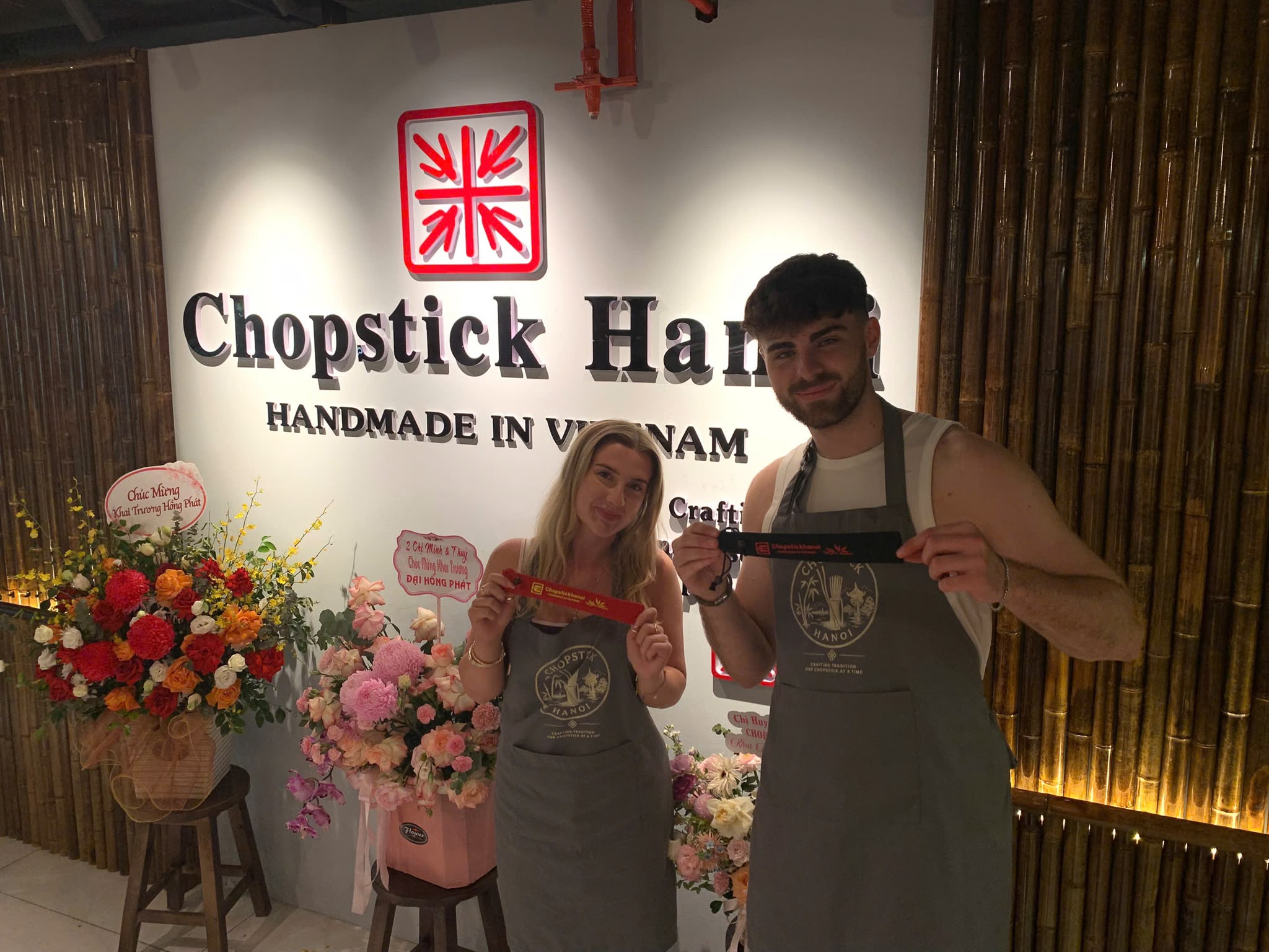 Two guests holding their finished chopsticks at Chopstick Hanoi