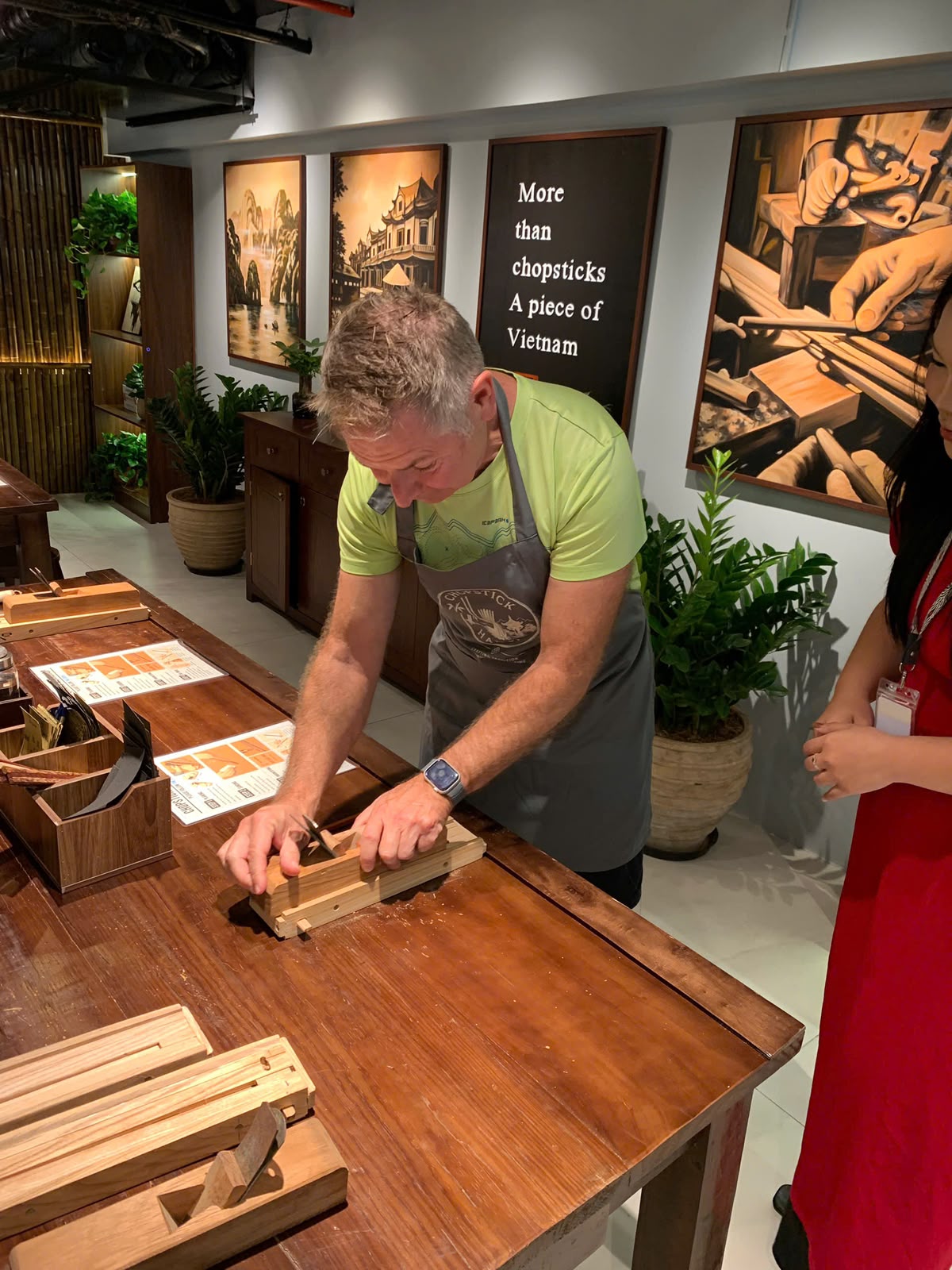 A guest using a hand plane to shape his chopsticks