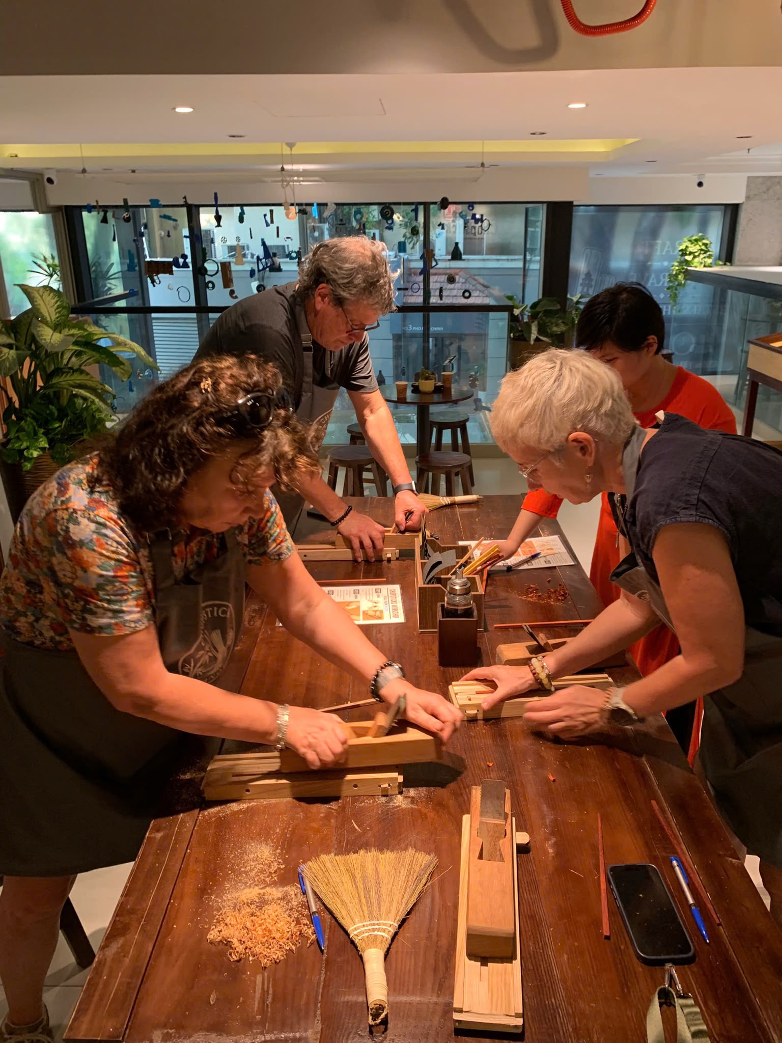 Guests learning to shape their chopsticks by hand with workshop guidance