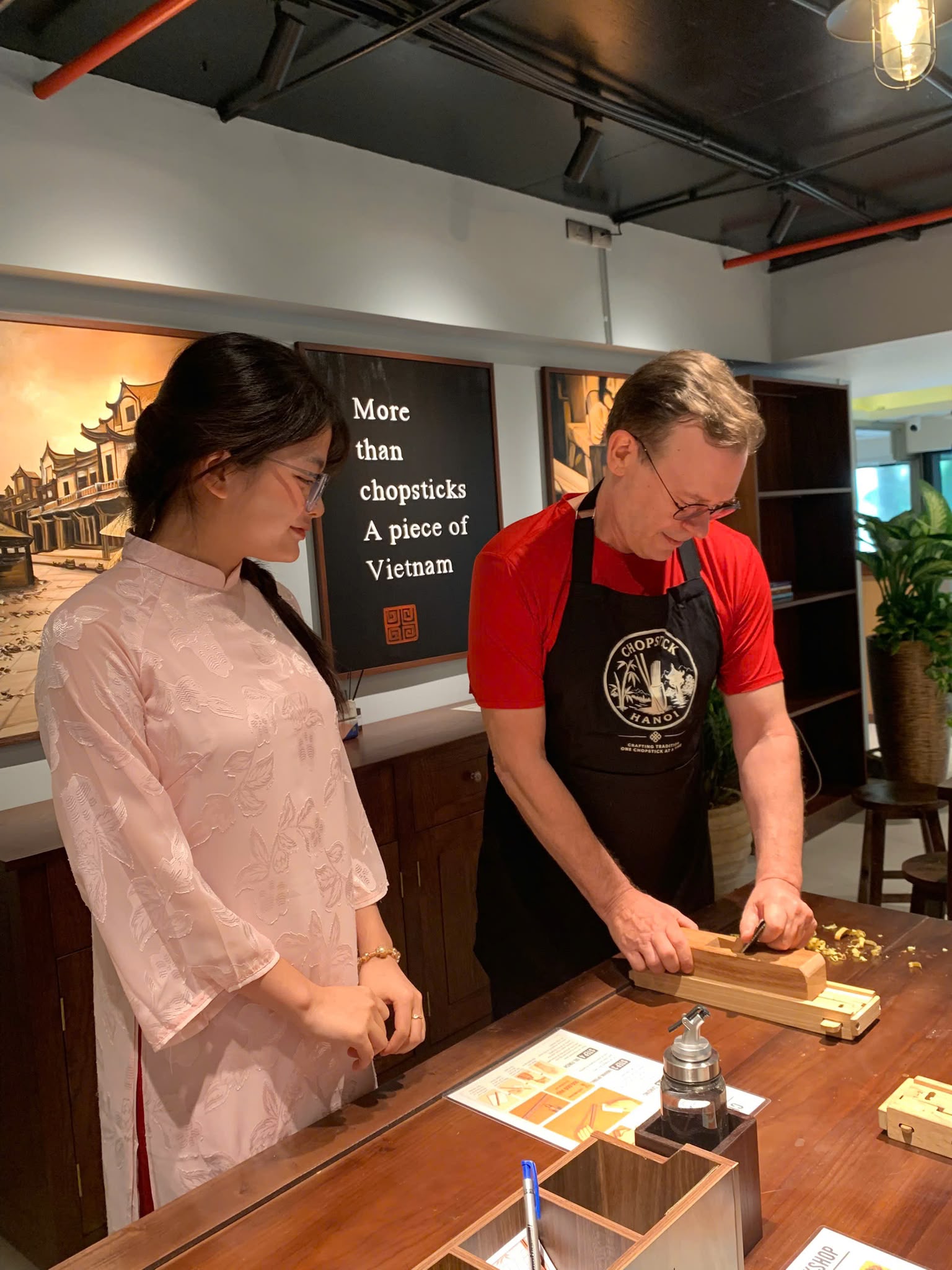 A guest shaping chopsticks with guidance from the Chopstick Hanoi team